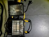 two lights that are sitting on the floor next to a bag