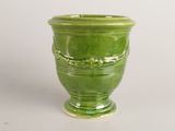 a green vase that is sitting on a table