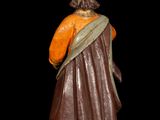 statue of a woman in a brown dress and orange top