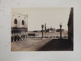 a black and white photo of a street with a clock tower