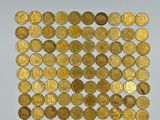 a close up of a pile of gold coins sitting on top of a table