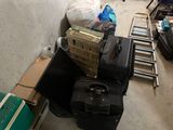several pieces of luggage are piled on the floor in a room