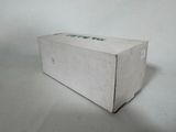 a white box with green writing on it sitting on a table