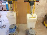 two machines that are sitting on the floor in the room