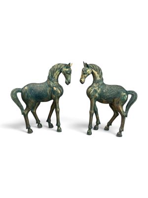 pair of bronze horse figurines on a white background