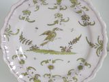 a plate with a bird on it sitting on a table