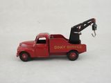 a red toy truck with a crane attached to it