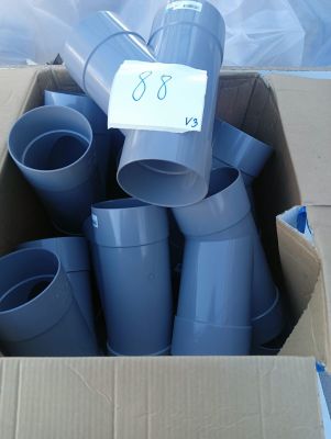 a cardboard box with a bunch of blue pipes in it