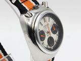 a watch with an orange and black band on a white background