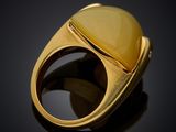 a close up of a ring with a yellow stone in it