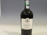 a bottle of wine sitting on a table next to a wine glass