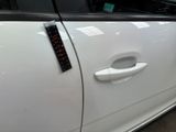 a white car that has a sticker on the side of it