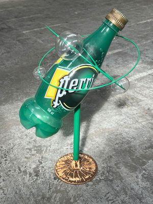 a bottle that is sitting on top of a metal stand
