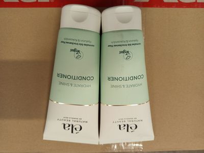 deux bouteilles d'après-shampoing posées sur une boîte en carton