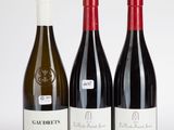 trois bouteilles de vin rouge et de vin blanc posées les unes à côté des autres