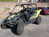 a yellow and black buggy parked in a parking lot