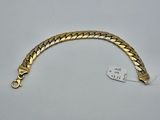 a gold bracelet with a clasp on a white background