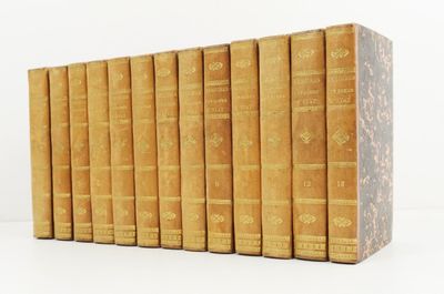 books are lined up in a row on a white surface