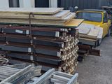 many pieces of metal on a pallet outside of a building
