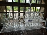 many wine glasses sitting on a table in front of a window