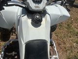a motorcycle that is parked on the grass in the field