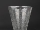 a close up of a glass vase on a black background