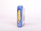 a blue box with a yellow label sitting on a white surface