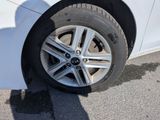 a close up of a tire on a white car