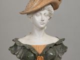 an image of a busturine of a woman with a hat on her head