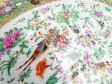 a plate with a bird and flowers design on it