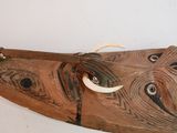 a wooden boat that has a long horn on it