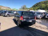 a black car parked in a parking lot next to other cars