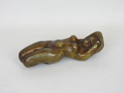 an old bronze figurine of a woman laying on her back