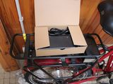 a red bike with a box on the back of it