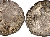 an old silver coin with a small inscription on it