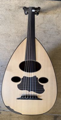 a guitar with a mustache on it hanging on a wall