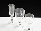 three empty wine glasses sitting on a white table
