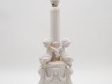 an image of a white table lamp with a bird on top of it
