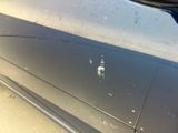 a close up of a car ' s door handle with a sticker on it