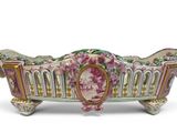 a picture of a decorative planter with flowers on it