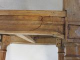 a close up of a wooden chair with a broken seat