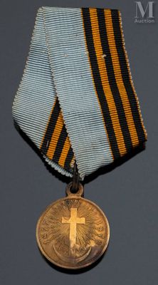 l'image d'une médaille sur laquelle figure une croix au recto