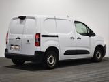 the back of a white van parked in a white room