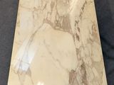 a close up of a marble table top on a blue carpet