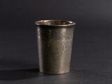 a silver cup that is sitting on a table