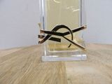 a bottle of perfume on a table with a pair of scissors