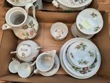 a box full of china dishes and cups and saucers