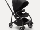 a black stroller with a black seat on a white background