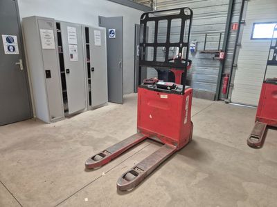 un chariot élévateur rouge garé dans un entrepôt