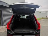 the back end of a black car with its trunk open